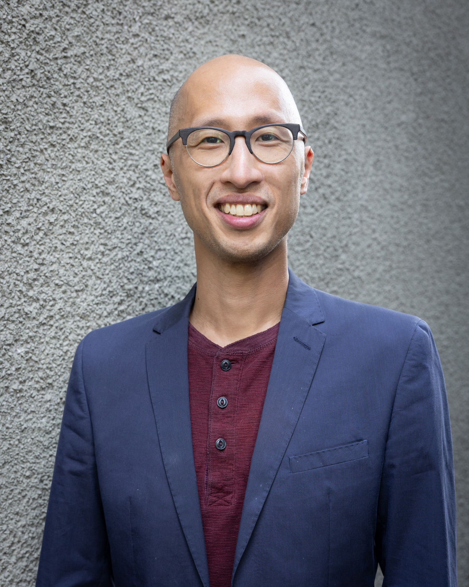 Headshot of Ryan Cho in a blue jacket.